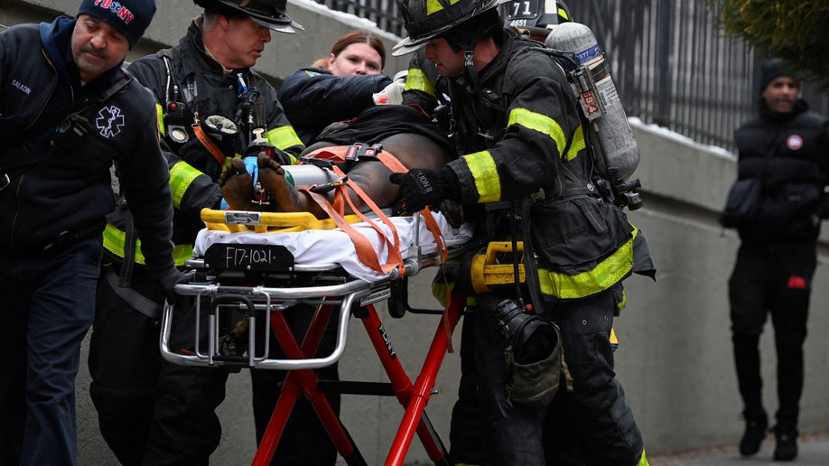 Emergency personnel from the FDNY provide medical aid.