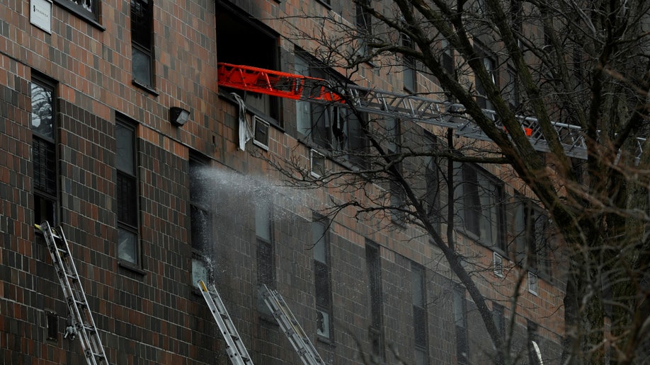 Emergency personnel from the FDNY respond to an apartment building fire in the Bronx borough of New York City.
