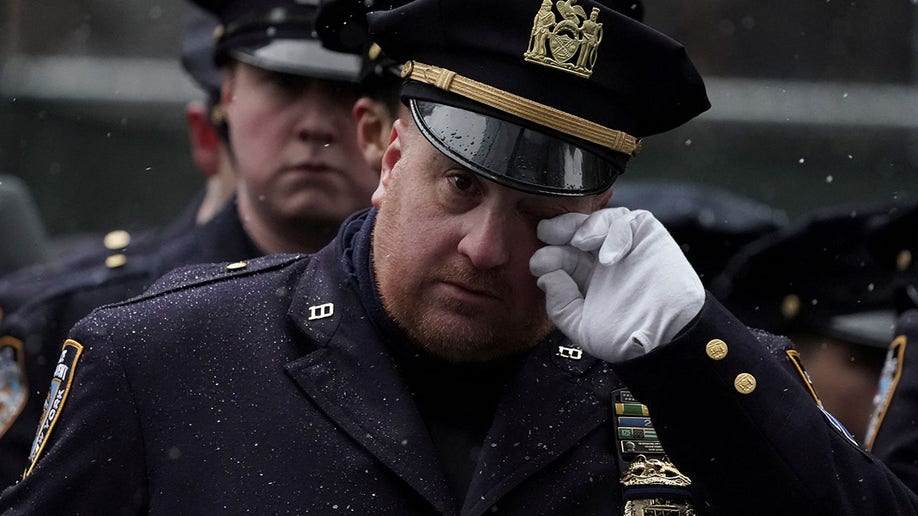 A police officer reacts during the funeral service for New York City Police Department (NYPD) officer Jason Rivera