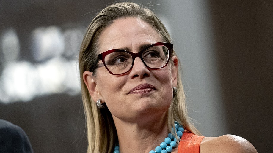 Sinema at a news conference