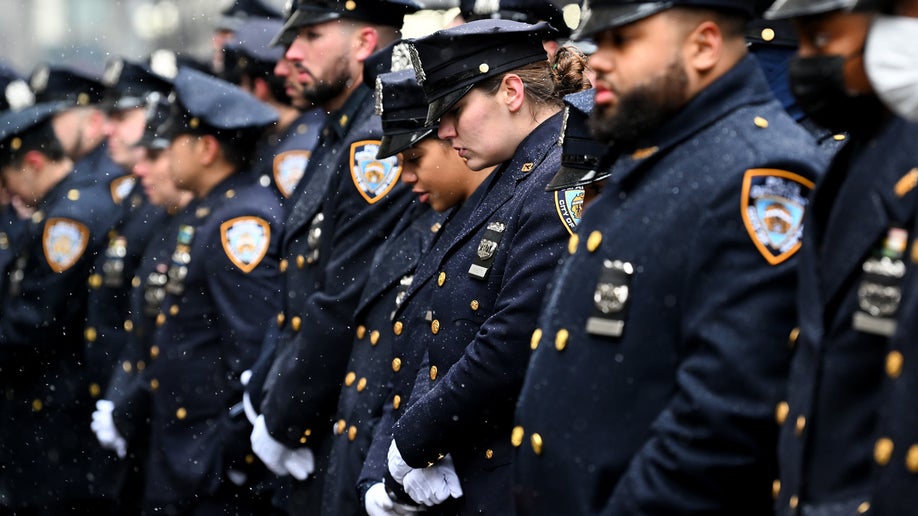 NYPD officers bow their heads for fallen NYPD Officer Jason Rivera following his funeral at St. Patrick’s Cathedral