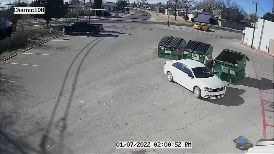 The video shows a woman pulling up in a white car around 2 p.m. MT Friday, unceremoniously tossing a black bag from the backseat into the dumpster and driving off.