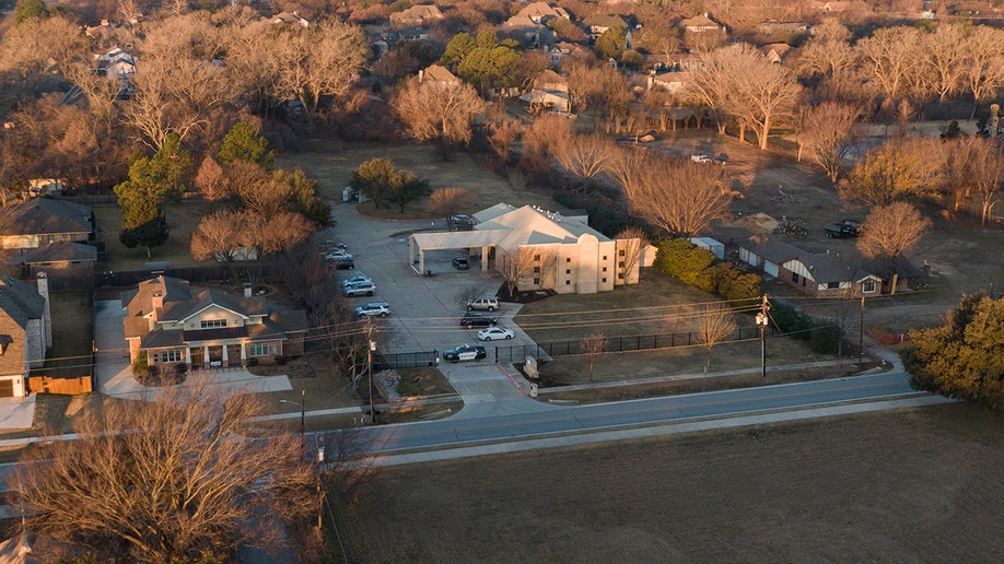 An aerial view of police standing in front of the Congregation Beth Israel synagogue, Sunday, Jan. 16, 2022, in Colleyville, Texas. 