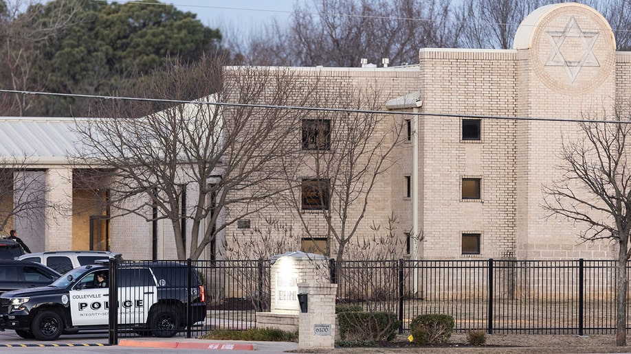 Police stand in front of the Congregation Beth Israel synagogue, Sunday, Jan. 16, 2022, in Colleyville, Texas.