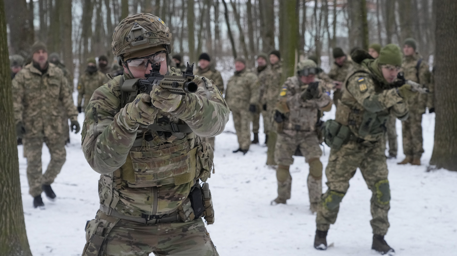 Members of Ukraine's Territorial Defense Forces, volunteer military units of the Armed Forces, train in a city park in Kyiv, Ukraine.