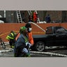 People walk at the scene of an apartment building fire in the Bronx borough of New York City