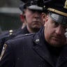 A police officer reacts during the funeral service for NYPD officer Jason Rivera, who was killed in the line of duty while responding to a domestic violence call, on Jan. 28, 2022. (REUTERS/Jeenah Moon)