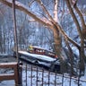 A commuter bus sits upright on a section of a collapsed bridge in Pittsburgh, on Friday, Jan. 28, 2022.  Police reported the span, on Forbes Avenue over Fern Hollow Creek in Frick Park, came down around 6 a.m. There were no initial reports of injuries, Pittsburgh Public Safety said on Twitter.  (Greg Barnhisel via AP)