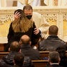 A priest hugs Dominique Rivera, the wife of NYPD Officer Jason Rivera during funeral services for Rivera, Friday, Jan. 28, 2022, at St. Patrick's Cathedral in New York.  (AP Photo/Mary Altaffer, POOL)