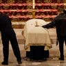 Family members touch the casket during a funeral service for NYPD officer Jason Rivera Friday, Jan. 28, 2022, at St. Patrick's Cathedral in New York. Rivera and his partner, Officer Wilbert Mora, were fatally shot when a gunman ambushed them in an apartment as they responded to a family dispute last week. (AP Photo/Mary Altaffer, POOL)