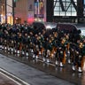 The Pipes and Drums Of The Emerald Society of the New York City Police Department march along Fifth Avenue outside St. Patrick's Cathedral during a funeral Service for officer Jason Rivera, Friday, Jan. 28, 2022, in New York.  (AP Photo/Yuki Iwamura)