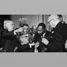 President Lyndon B. Johnson shakes the hand of Dr. Martin Luther King Jr. at the signing of the Civil Rights Act while officials look on in Washington D.C. 