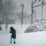 A pedestrian walks through a gust of wind along the waterfront in India Point Park in Providence, R.I., Saturday, Jan. 29, 2022.