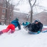 Kids play in the snow during a snow storm in Washington Sq. Park on Saturday, Jan. 29, 2022, in New York.