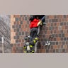 A firefighter helps a resident escape the Bronx apartment building fire