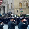 Officers salute during the procession for Jason Rivera.
