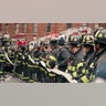 Firefighters work outside an apartment building after a fire in the Bronx