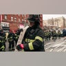 Firefighters work outside an apartment building after a fire in the Bronx
