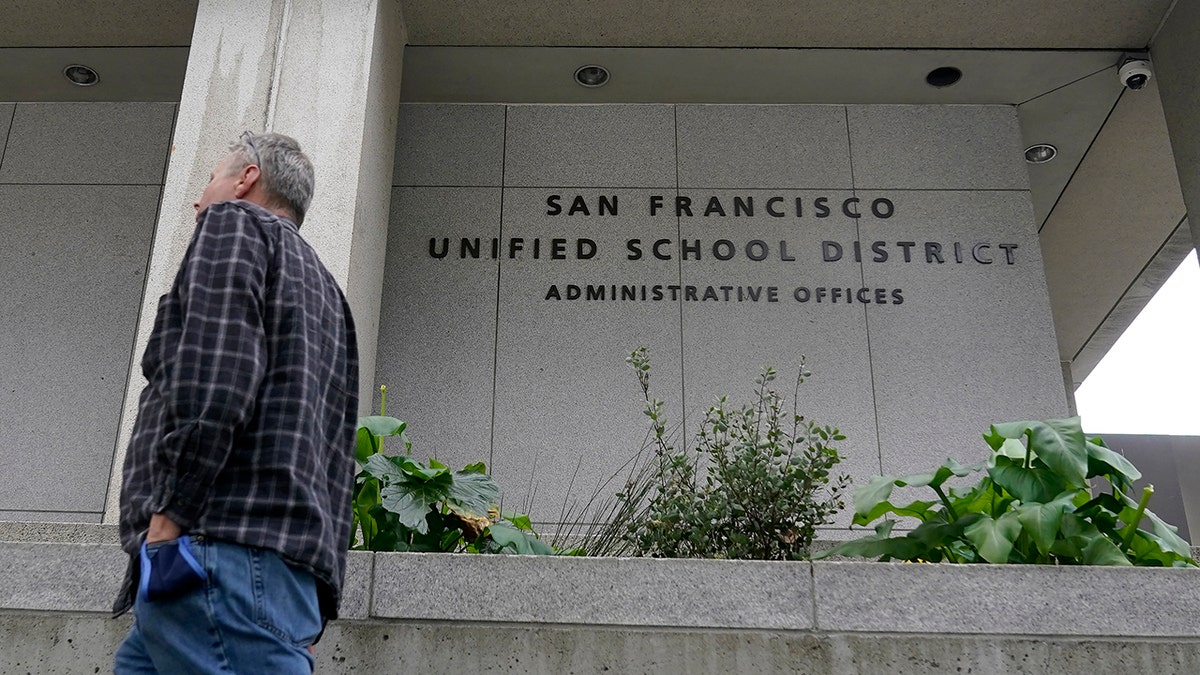 A pedestrian walks past a San Francisco Unified School District office building in San Francisco, Thursday, Feb. 3, 2022. 
