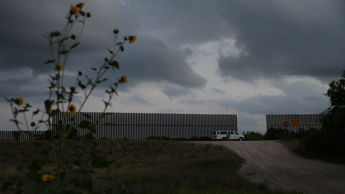 A border patrol agent guards a gap in the Mexico-U.S. border fence in the Rio Grande Valley sector, near McAllen, Texas, U.S., April 5, 2018.
