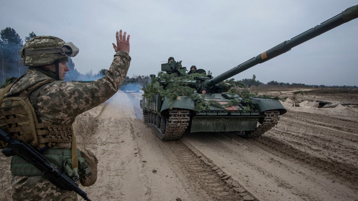 Ukrainian service members take part in tactical drills at a training ground in an unknown location in Ukraine, in this handout picture released Feb. 22, 2022. 