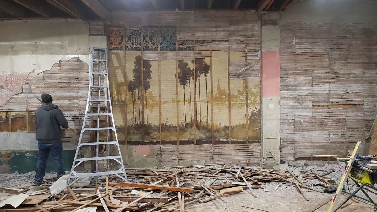 Nick Timm, U.S. Air Force veteran and managing partner of Solutions Weed and Pest Control, worked with his team to repair the old building he purchased with his wife. They eventually discovered two murals were hidden behind plaster walls.
