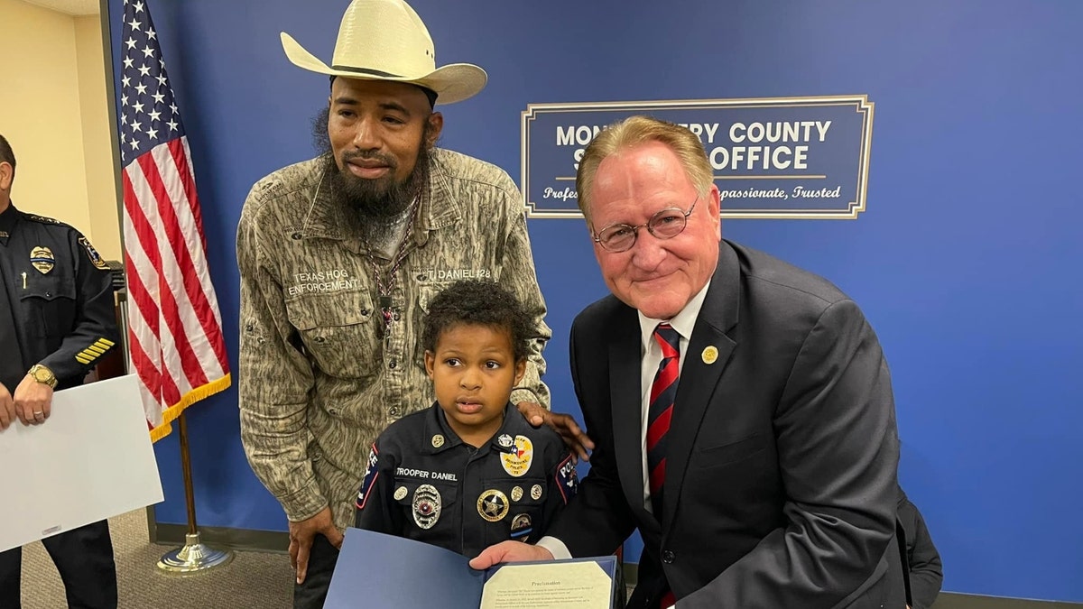 Devarjaye "DJ" Daniel, 10, is sworn into his 100th law enforcement agency. (Montgomery County Judge Mark Keough)