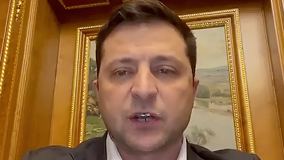 Ukrainian President Volodymyr Zelenskyy addresses the nation in a video Thursday morning from Kyiv. Zelenskyy declared martial law, saying Russia has targeted Ukraine's military infrastructure. He urged Ukrainians to stay home and not to panic. (Ukrainian Presidential Press Office via AP)