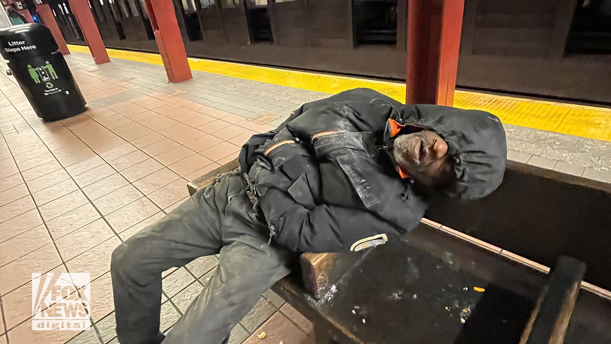 Man sleeping in subway station.
