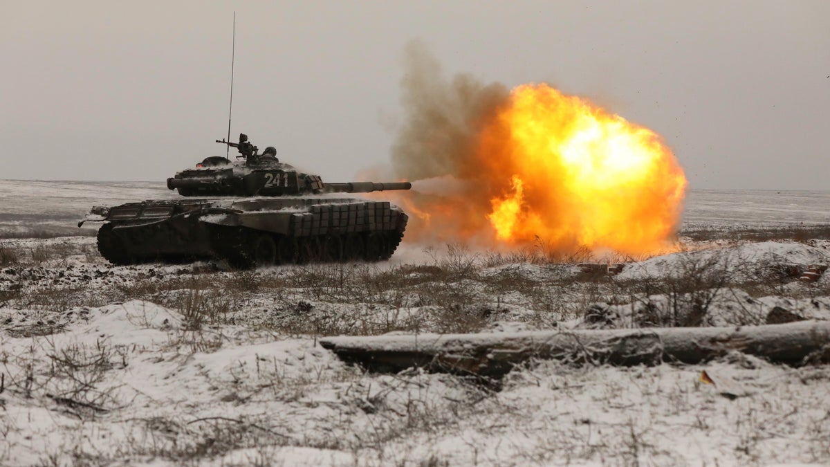 A Russian T-72B3 tank fires as troops take part in drills at the Kadamovskiy firing range in the Rostov region in southern Russia, Wednesday, Jan. 12, 2022. 