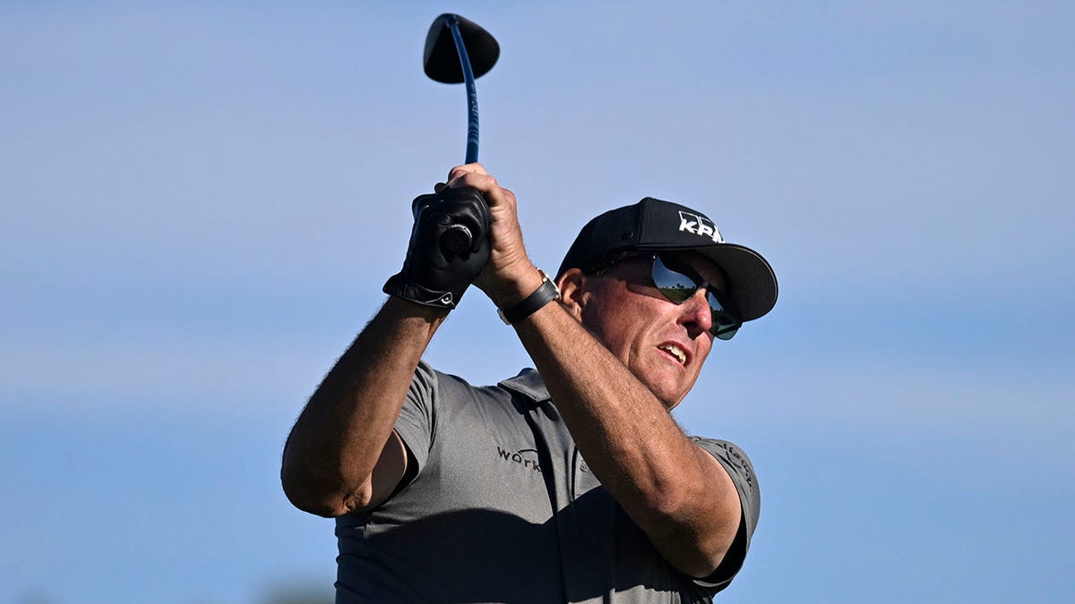 Phil Mickelson hits his tee shot on the fifth hole of the South Course at Torrey Pines during the first round of the Farmers Insurance Open golf tournament, Wednesday Jan. 26, 2022, in San Diego.