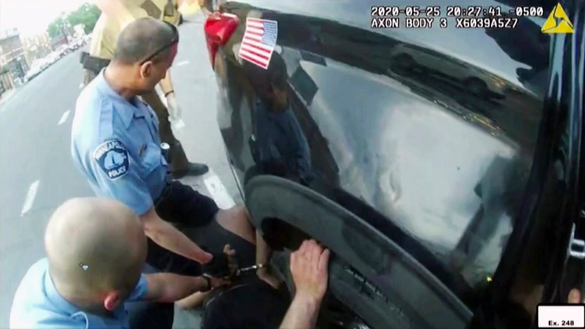 In this image from police body camera video shown as evidence in court, paramedics arrive as Minneapolis police officers, including Derick Chauvin, second from left, and J. Alexander Kueng restrain George Floyd in Minneapolis, on May 25, 2020.
