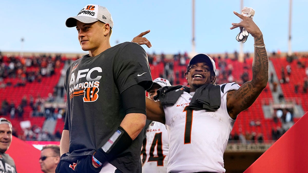 Cincinnati Bengals quarterback Joe Burrow, left, and wide receiver Ja'Marr Chase (1) celebrate after the AFC championship NFL football game against the Kansas City Chiefs, Sunday, Jan. 30, 2022, in Kansas City, Missouri. 