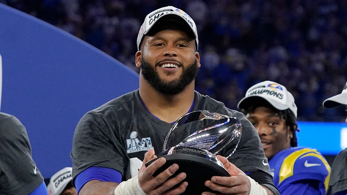 The Los Angeles Rams' Aaron Donald holds the George Halas trophy after the NFC Championship NFL football game against the San Francisco 49ers Sunday, Jan. 30, 2022, in Inglewood, California.