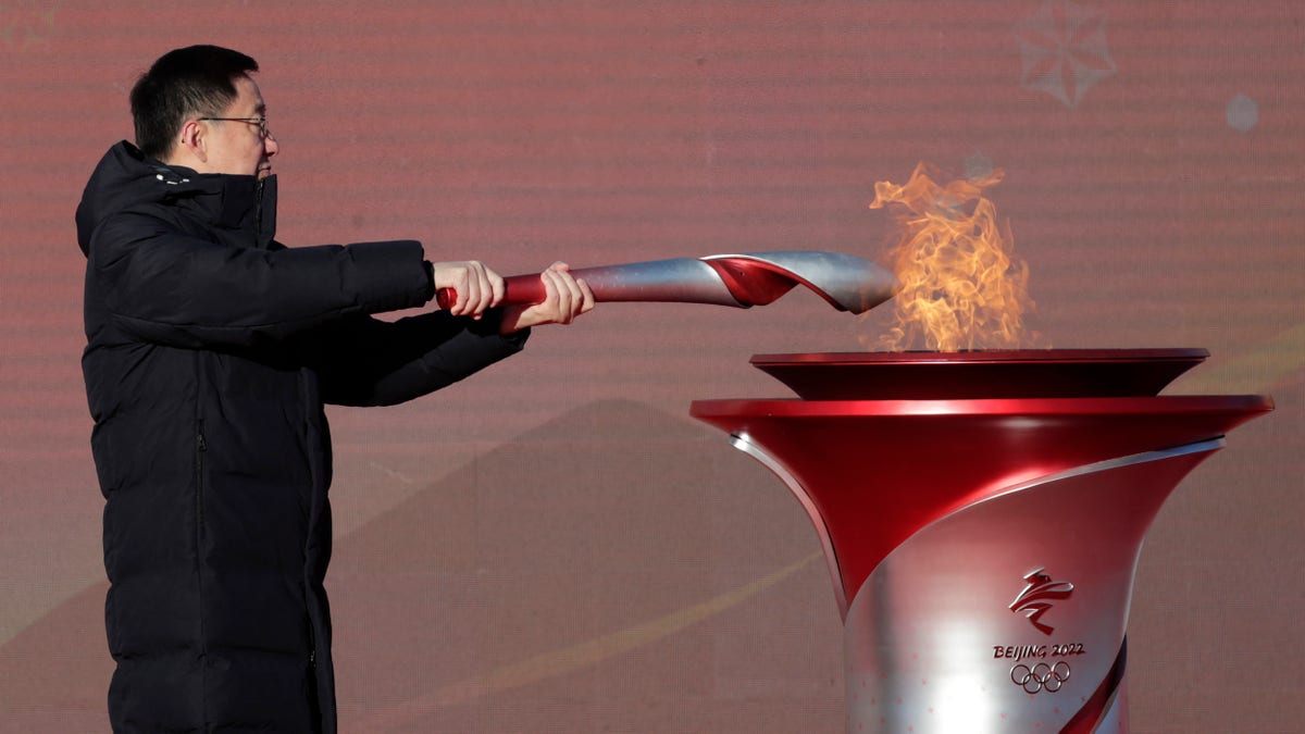 Chinese Vice Premier Han Zheng lights the torch before the start of the torch relay for the 2022 Winter Olympics at the Olympic Forest Park in Beijing on Wednesday, Feb. 2, 2022. 