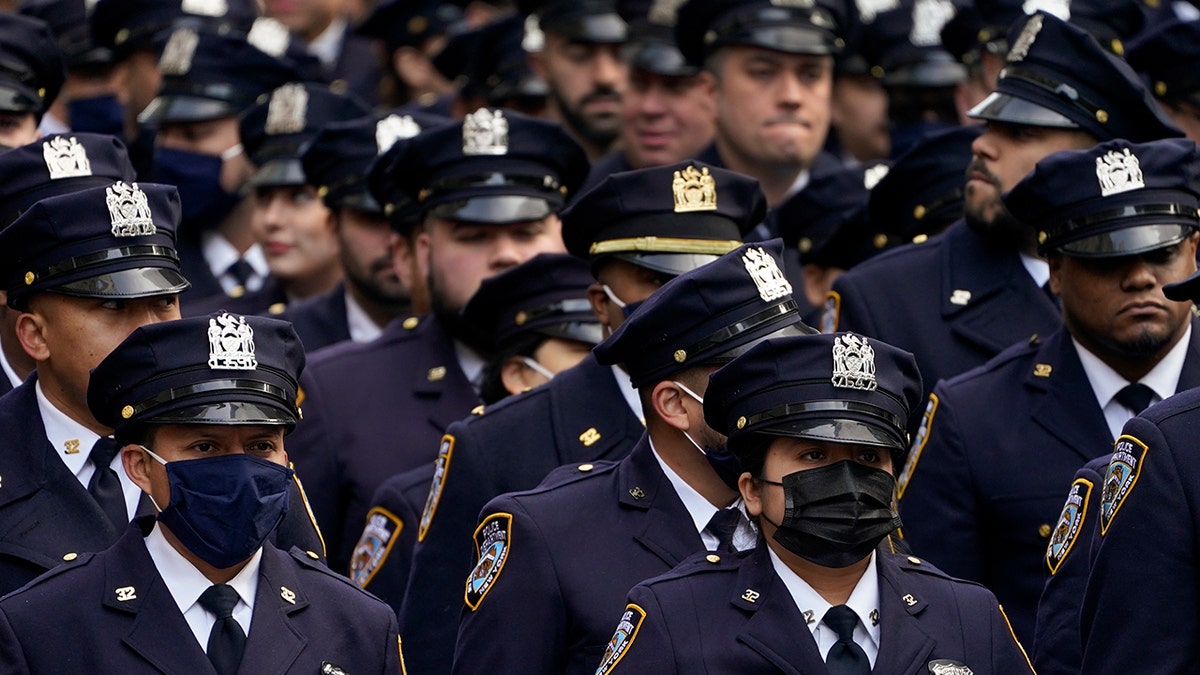 New York Police officers gather outside St. Patrick's Cathedral for Officer Wilbert Mora's funeral, Wednesday, Feb. 2, 2022, in New York.