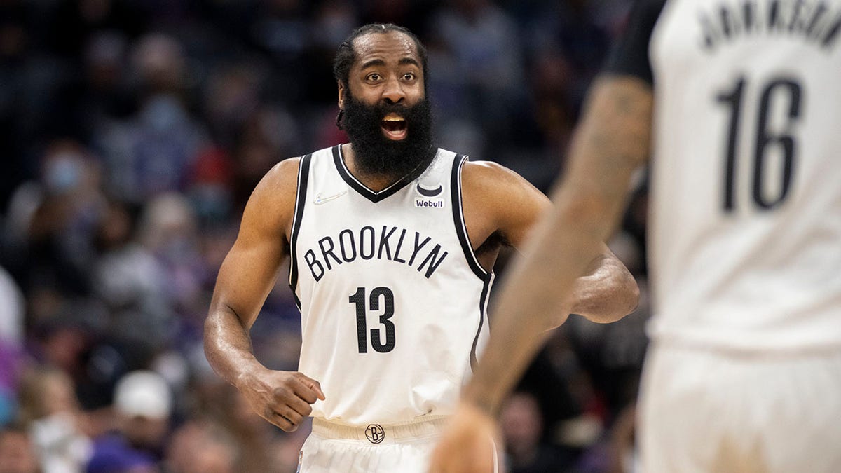 Brooklyn Nets guard James Harden (13) yells to forward James Johnson (16) during the second half of the team's NBA basketball game against the Sacramento Kings in Sacramento, California, Wednesday, Feb. 2, 2022.