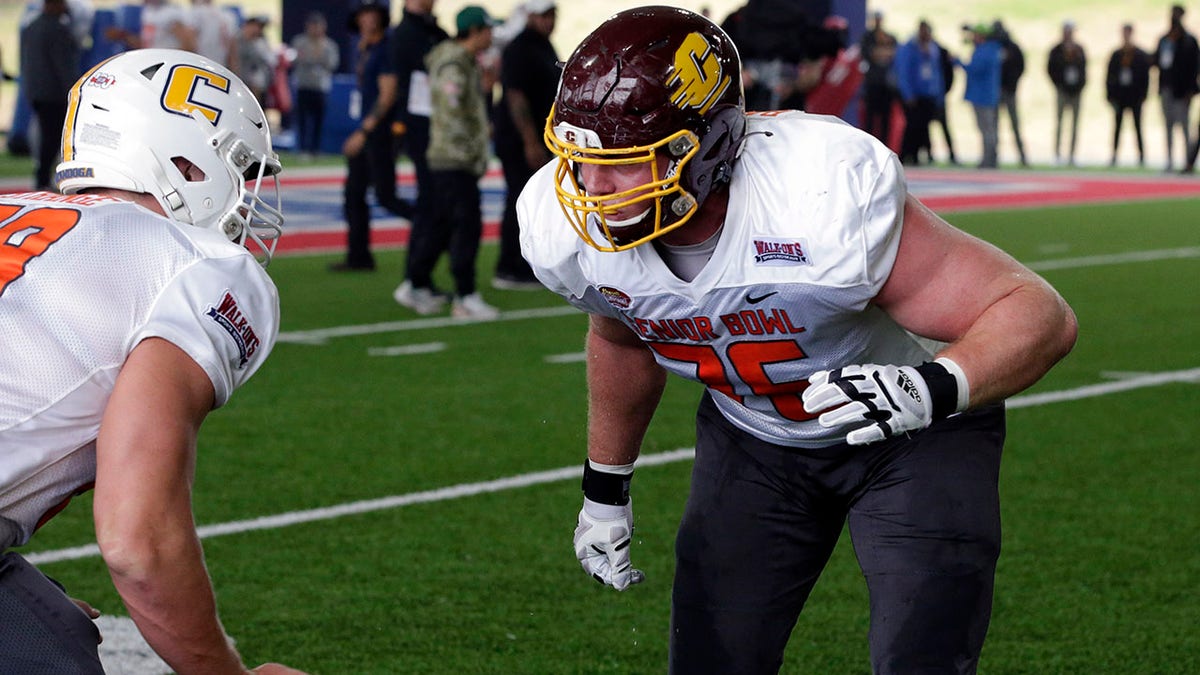 National Team offensive lineman Cole Strange of UT-Chattanooga and offensive lineman Bernhard Raimann of Central Michigan run through drills during practice for the Senior Bowl NCAA college football game Thursday, Feb. 3, 2022, in Mobile, Ala.