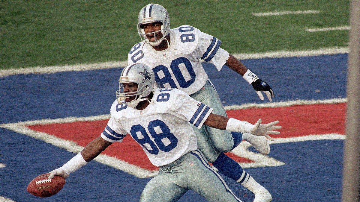 Dallas Cowboys Michael Irvin (88) celebrates as teammate Alvin Harper (80) comes in to offer congratulations after a second-quarter touchdown reception against the Buffalo Bills in NFL football's Super Bowl XXVII in Pasadena, Calif., Jan. 31, 1993.