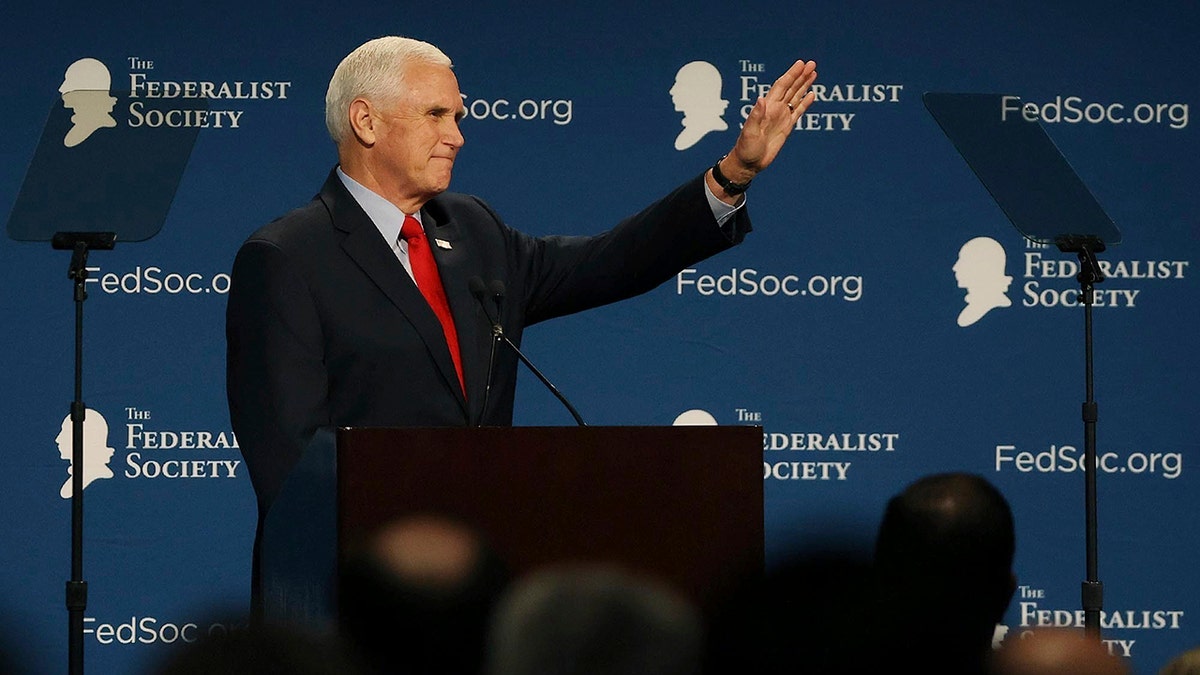 Former Vice President Mike Pence waves to attendees at the Florida chapter of the Federalist Society's annual meeting at Disney's Yacht Club resort in Walt Disney World on Friday, Feb. 4, 2022, in Lake Buena Vista, Fla. (Stephen M. Dowell/Lake Buena Vista Sentinel via AP)