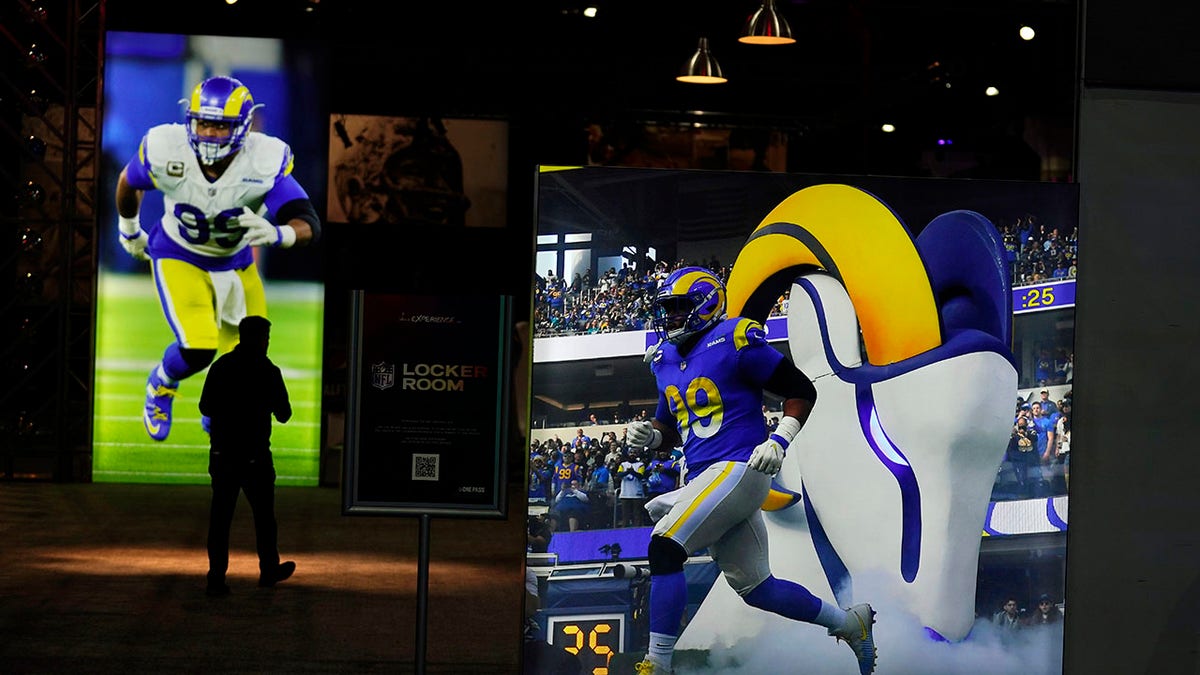 Images of Los Angeles Rams defensive end Aaron Donald are displayed inside the NFL Experience, an interactive fan show, Friday, Feb. 4, 2022, at the Los Angeles Convention Center in Los Angeles. The Rams are scheduled to play the Cincinnati Bengals in the Super Bowl NFL football game Feb. 13 in Inglewood, Calif.