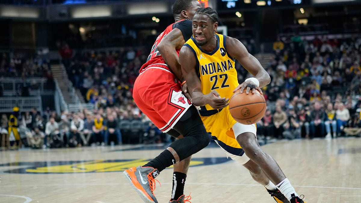 Indiana Pacers guard Caris LeVert, right, drives around Chicago Bulls forward Javonte Green during the first half of an NBA basketball game in Indianapolis, Friday, Feb. 4, 2022.