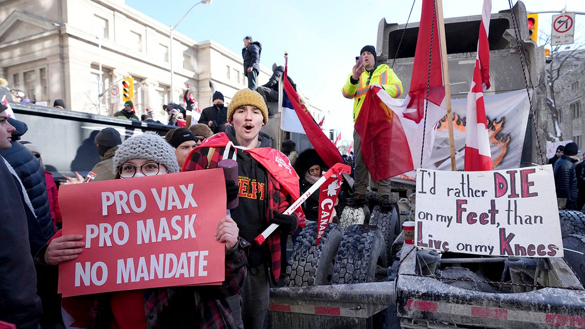 A protester in support of masks and vaccines makes their way through a demonstration in support of a trucker convoy in Ottawa protesting COVID-19 restrictions, at Queen's Park in Toronto, Saturday, Feb. 5, 2022. 