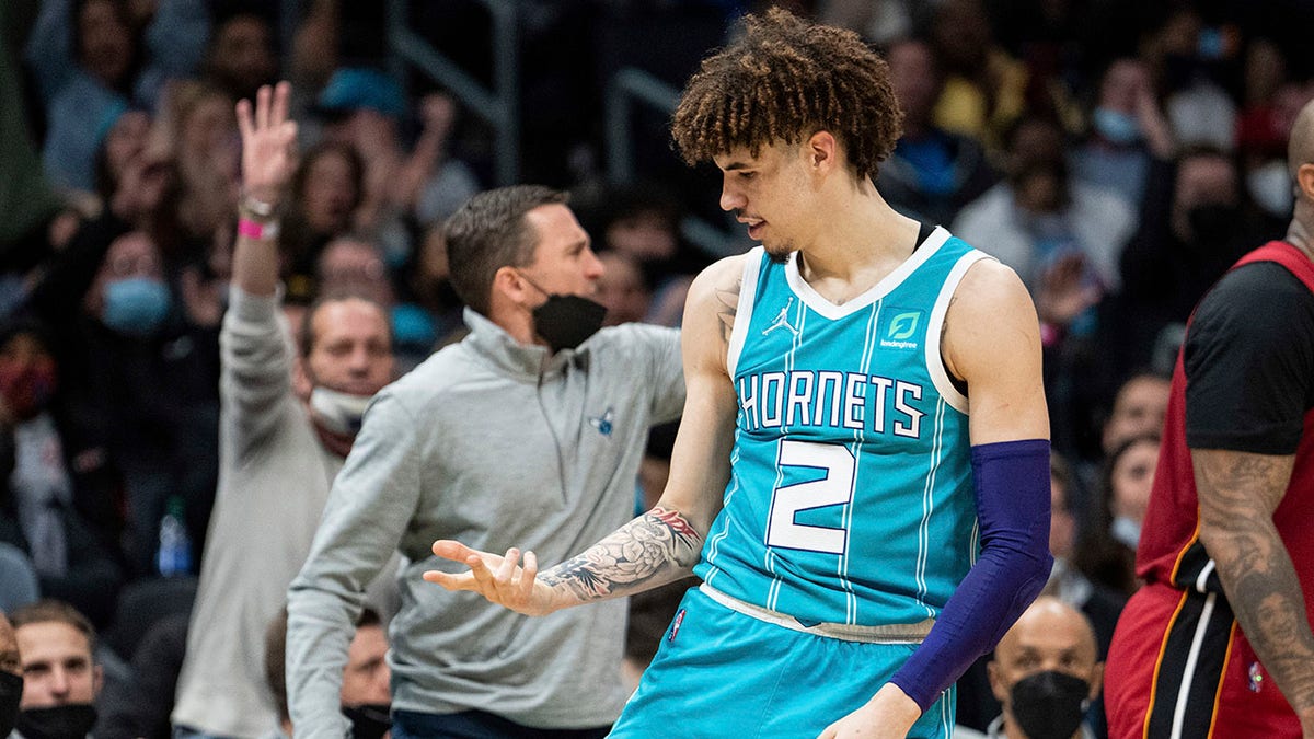 Charlotte Hornets guard LaMelo Ball (2) reacts after making a 3-point shot against the Miami Heat during the first half of an NBA basketball game in Charlotte, N.C., Saturday, Feb. 5, 2022.