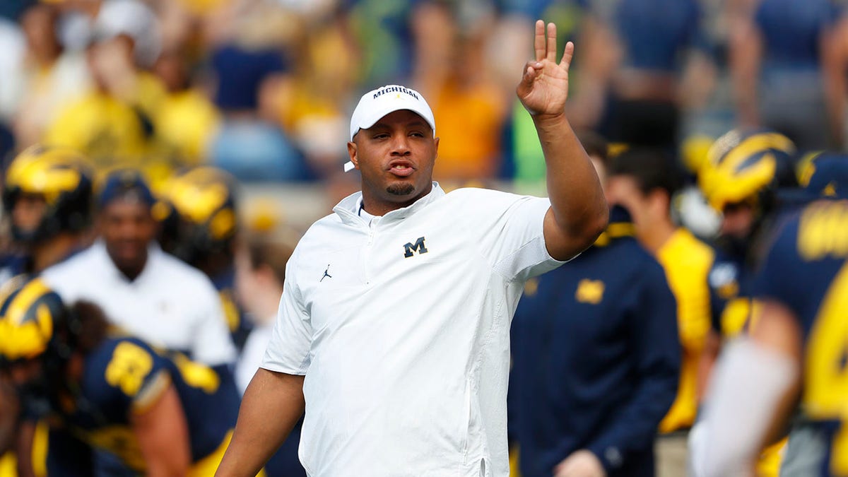 FILE - Michigan offensive coordinator Josh Gattis watches during warmups before an NCAA college football game in Ann Arbor, Mich., Saturday, Sept. 7, 2019. According to a person with knowledge of the deal who told The Associated Press on Sunday, Feb. 6, 2022, Miami is hiring Gattis to run new coach Mario Cristobal’s offense with the Hurricanes.