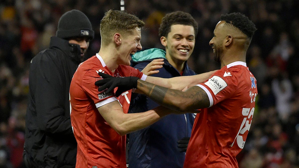 Nottingham Forest's Ryan Yates, Brennan Johnson and Cafu, from left, celebrate at the end of the English FA Cup fourth round soccer match between Nottingham Forest and Leicester City at the City Ground, Nottingham, England, Sunday, Feb. 6, 2022. Nottingham Forest won 4-1.