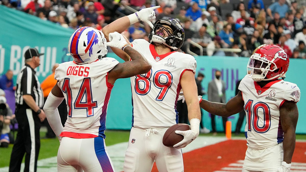 AFC tackle Mark Andrews (89), of the Baltimore Ravens, reacts with wide receiver Stefon Diggs (14), of the Buffalo Bills, and wide receiver Tyreek Hill (10), of the Kansas City Chiefs, after Andrews scored a touchdown in the first half of the Pro Bowl NFL football game against the NFC, Sunday, Feb. 6, 2022, in Las Vegas.