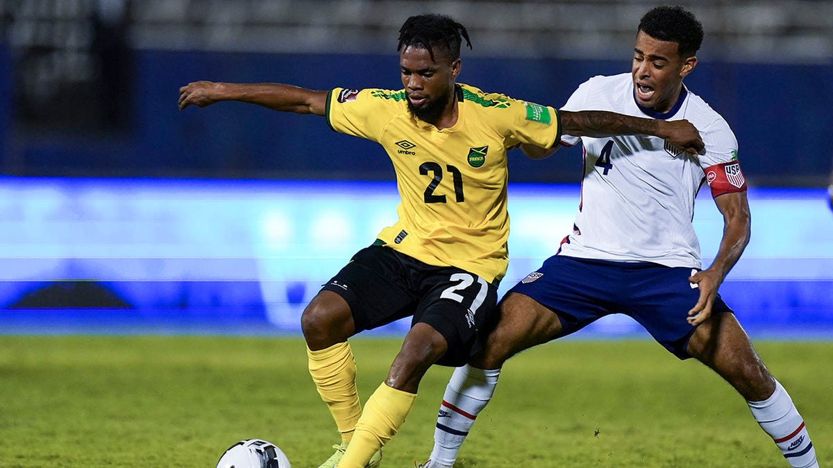FILE - Jamaica's Lemar Walker (21) dribbles the ball challenged by United States' Tyler Adams during a qualifying soccer match for the FIFA World Cup Qatar 2022 in Kingston, Jamaica, Tuesday, Nov. 16, 2021. FIFA has dismissed a protest filed by the Jamaica Football Federation over its 1-1 draw with the United States in a World Cup qualifier on Nov. 16. In a 34-point, eight-page decision, FIFA's disciplinary committee said Jamaica failed to notify the match commissioner of the protest and failed to make a payment of 1,000 Swiss francs (then $1,075) to accompany the protest.