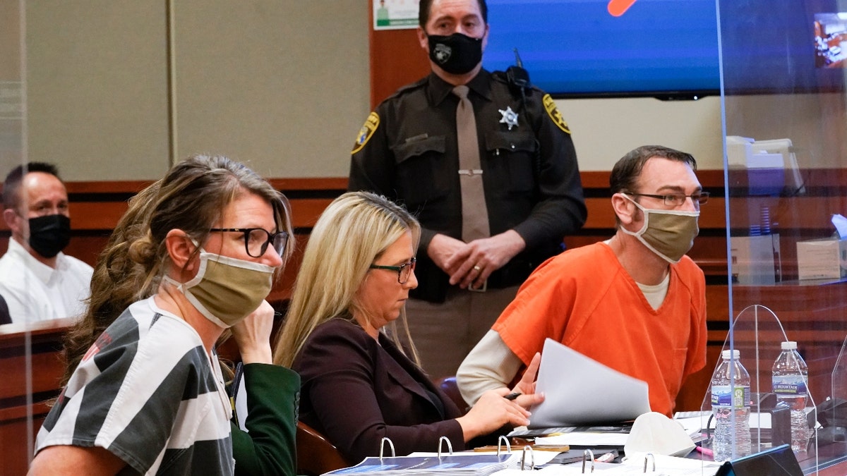 Jennifer Crumbley, left, and James Crumbley, right, the parents of Ethan Crumbley, a teenager accused of killing four students in a shooting at Oxford High School, appear in court for a preliminary examination on involuntary manslaughter charges in Rochester Hills, Mich., Tuesday, Feb. 8, 2022. (AP Photo/Paul Sancya)