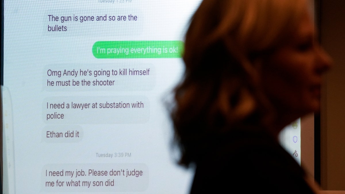 Texts are shown from Jennifer Crumbley, mother of Ethan Crumbley, a teenager accused of killing four students in a shooting at Oxford High School, to a co-worker Andrew Smith as Oakland County Prosecutor Karen McDonald speaks in court for a preliminary examination on involuntary manslaughter charges in Rochester Hills, Mich., Tuesday, Feb. 8, 2022. (AP Photo/Paul Sancya)